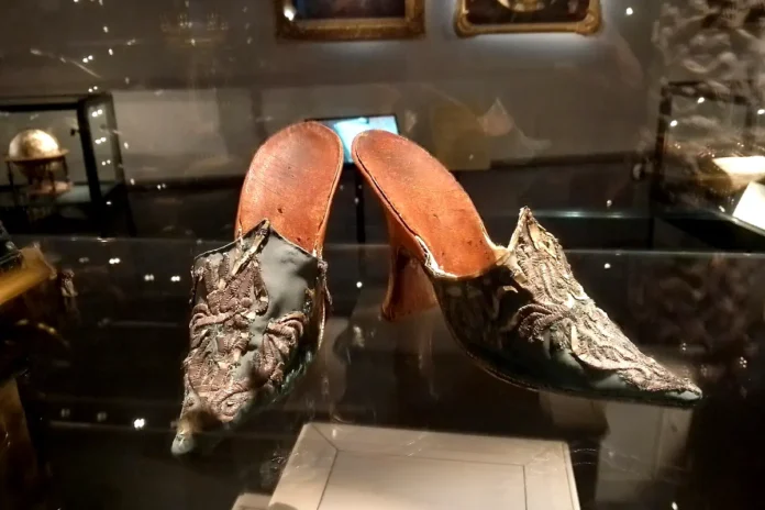 Women’s shoes from the early 18th century, made of silk, silver, and parchment.